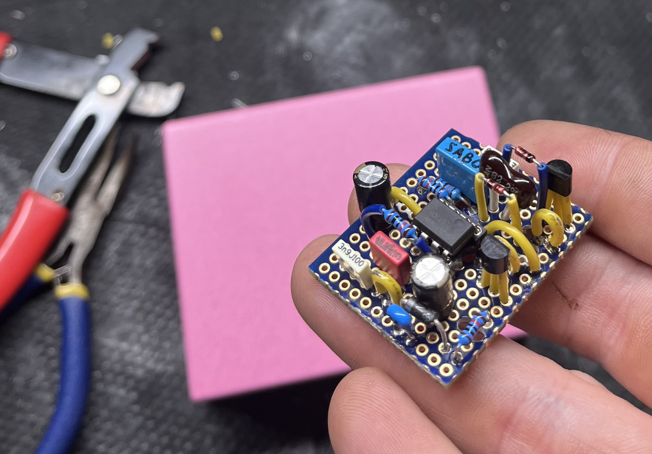 Hand-wired DixonFX circuit board on the bench, pliers behind