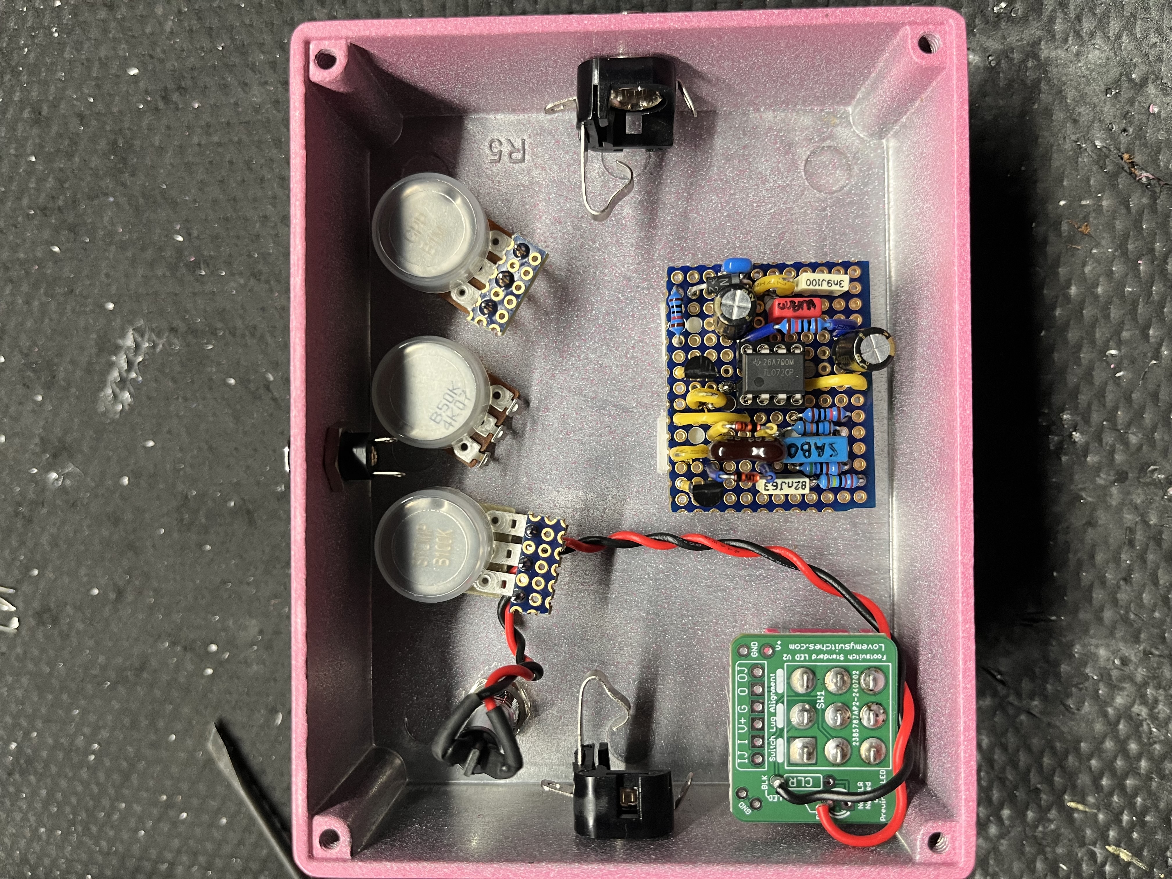 Inside a DixonFX enclosure — hand-wired pots, board, and footswitch