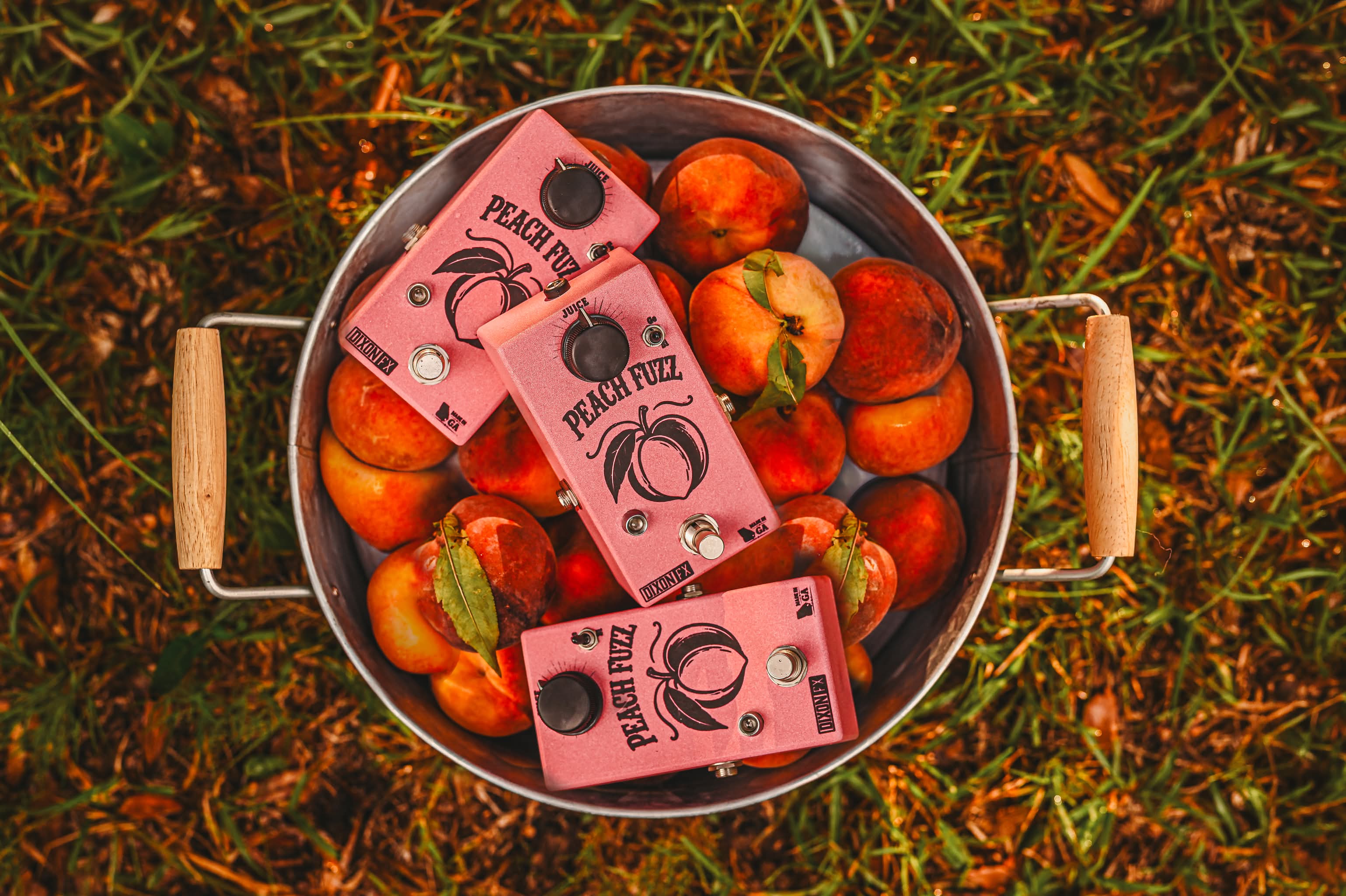 Peach State Fuzz pedals in a bucket of peaches